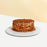Tiramisu cake coated with caramelized almonds, dusted with cocoa powder