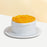 Sponge cake with cream cheese frosting, topped with mango slices