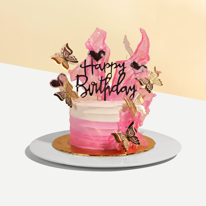 Two-toned buttercream icing cake, decorated with paper butterflies
