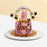 Pink and purple buttercream cake, with a pink haired figurine