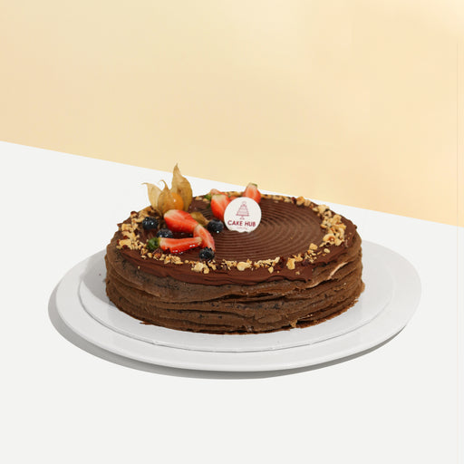 Hazelnut chocolate mille crepe, topped with crushed nuts and fresh fruit