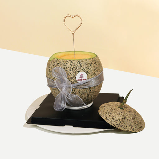 Vanilla sponge cake with pastry cream and fresh fruits, inside a melon