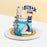 Cake decorated in a sailor theme, with a toy boat and lighthouse