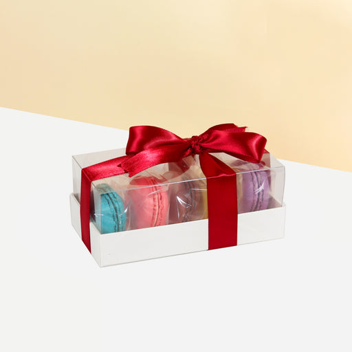 Macaron box with 5 pieces of macarons, in a see through box tied with a red ribbon