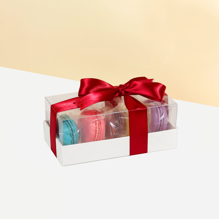 Macaron box with 5 pieces of macarons, in a see through box tied with a red ribbon