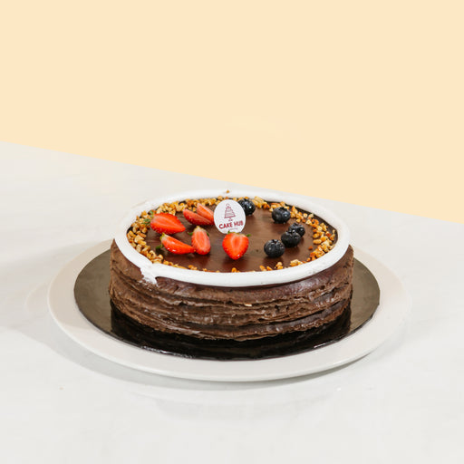 Mille crepe with peanut cream layers, topped with chocolate ganache and peanut crumbs
