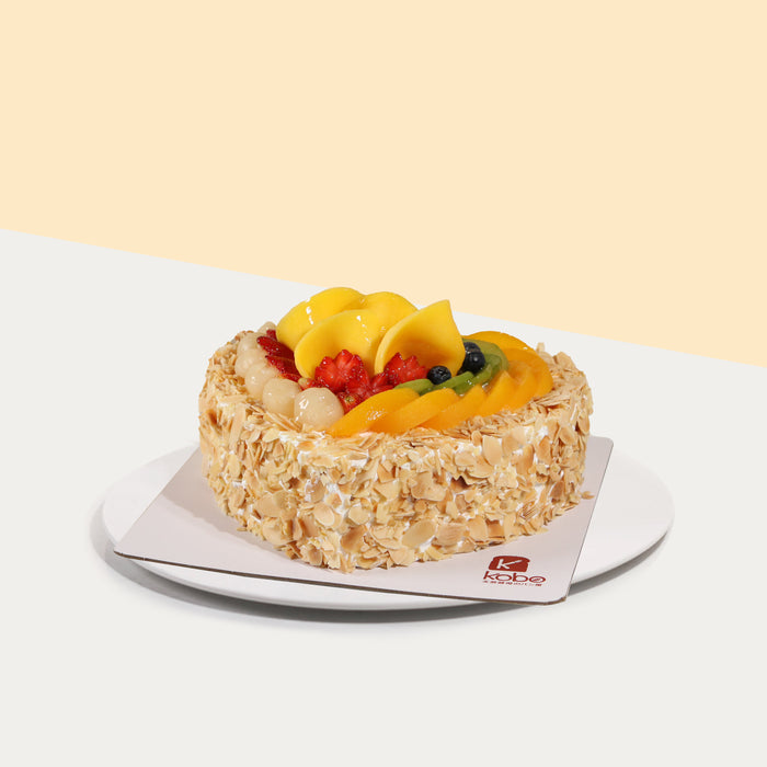 Heart shaped chiffon cake with fresh cream and almond flakes, topped with fresh fruits