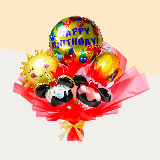 A bouquet for kids featuring two cartoon mouse ears, two smileys and a Happy Birthday foil balloon