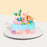 Blue cream cake with white chocolate mermaid decorations and macarons