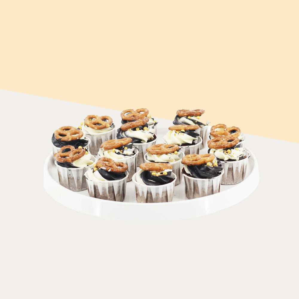 Cupcakes with marble black and white buttercream, and pretzels