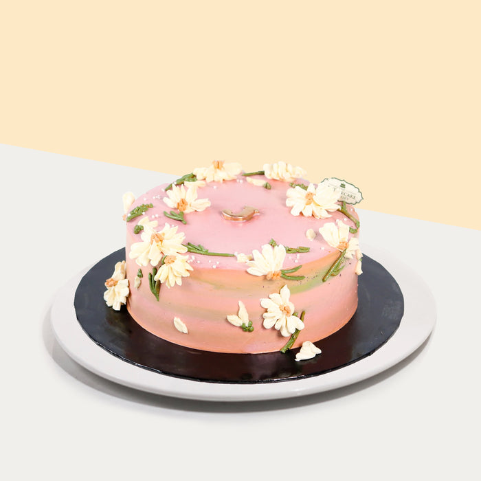 Korean inspired pink buttercream cake with hand piped daisy petals