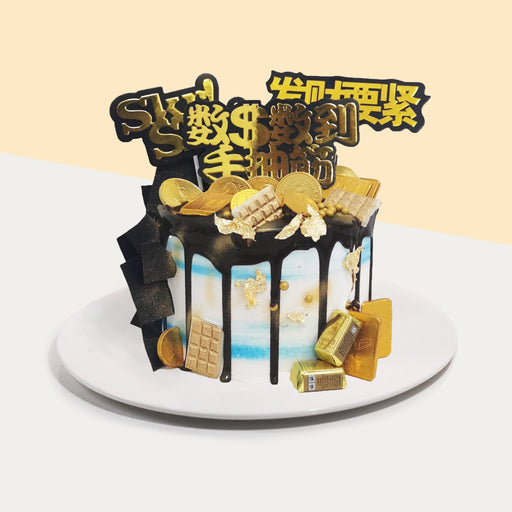 Blue buttercream cake with golden decorations
