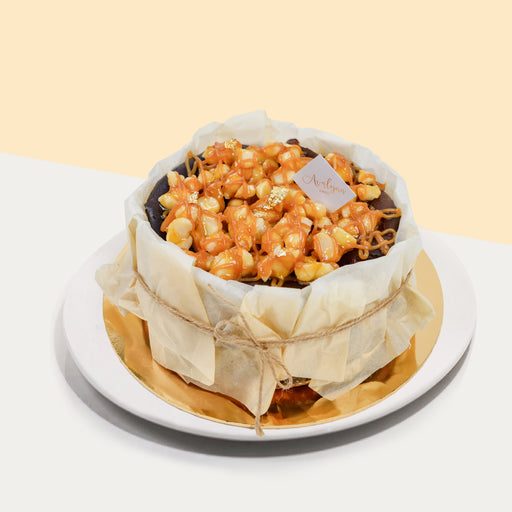 Basque burnt cheesecake, topped with macadamia nuts drizzled with salted caramel sauce