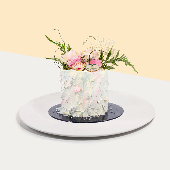 Hand-painted pastel buttercream topped with fresh flowers