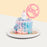 Blue and pink cake, decorated with edible pearls, chocolate sprinkles and a unicorn toy